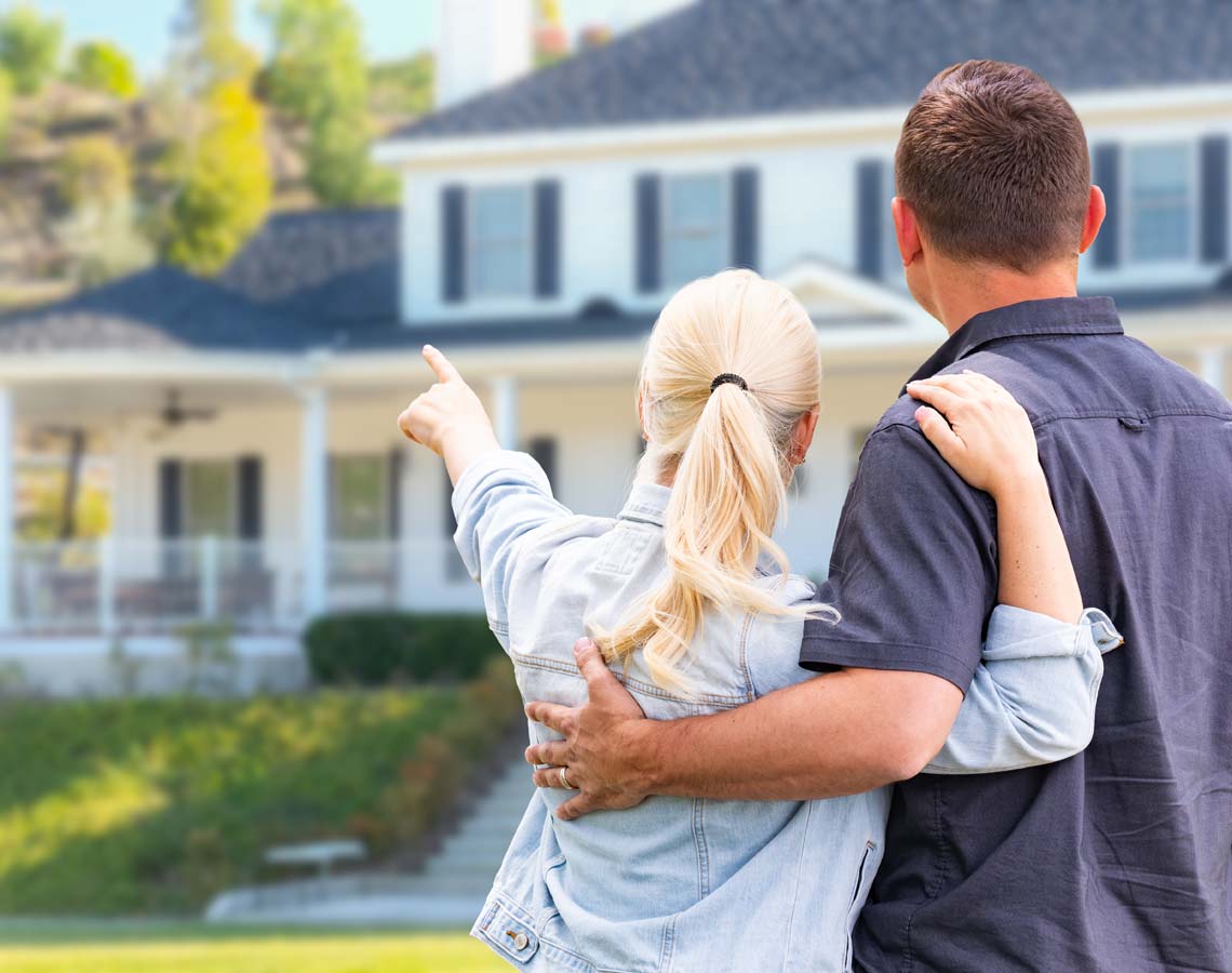 Couple In Front Of Air Conditioned House