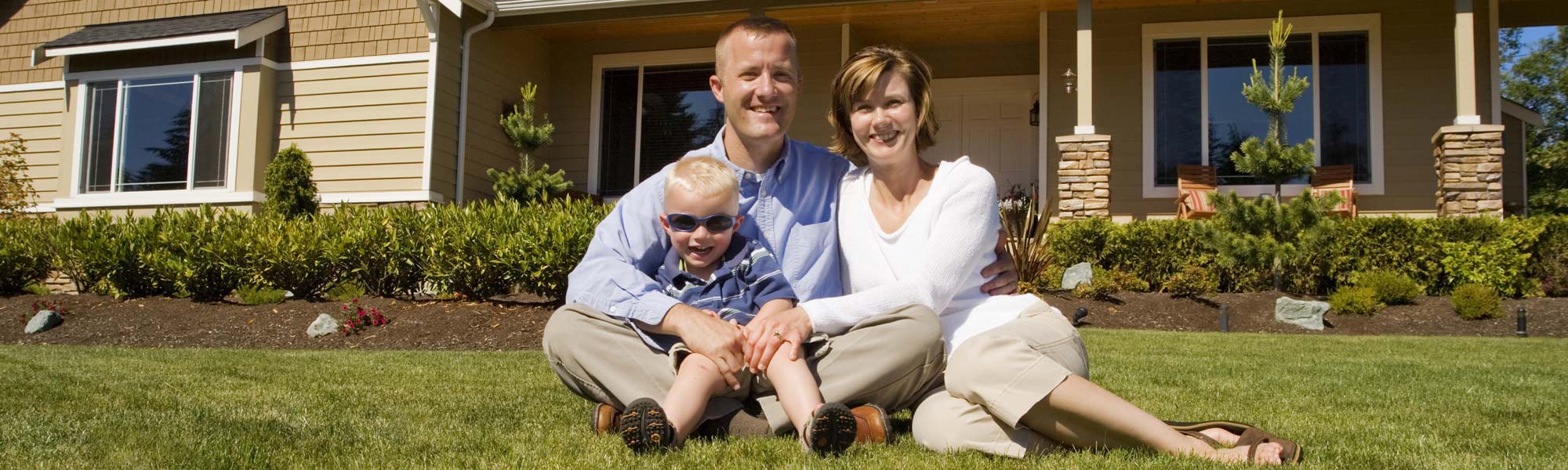 Family In Front Of Air Conditioned House